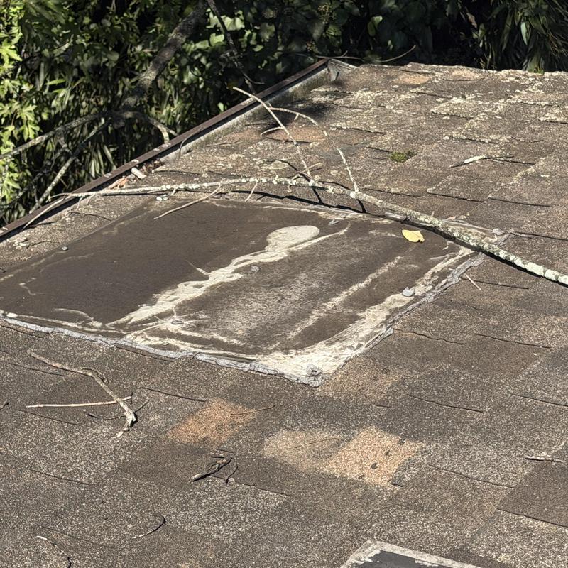 Skylight flashing with damaged roof shingles Skylight flashing with damaged roof shingles