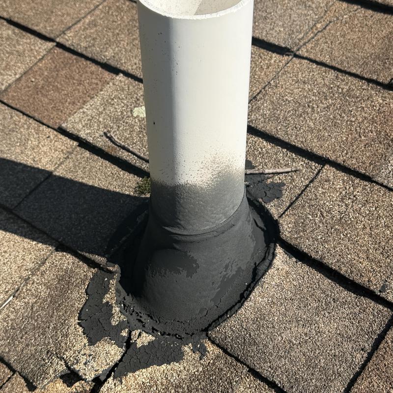 Vent pipe flashing with cracked sealant on asphalt roof shingles Vent pipe flashing with cracked sealant on asphalt roof shingles