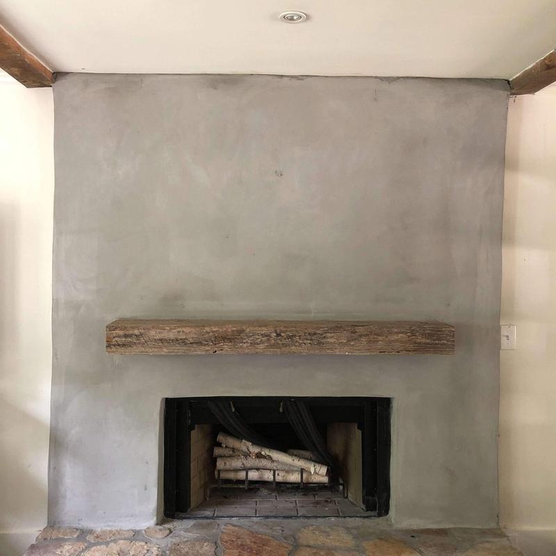 Concrete fireplace surround with wooden mantel installed Concrete fireplace surround with wooden mantel installed