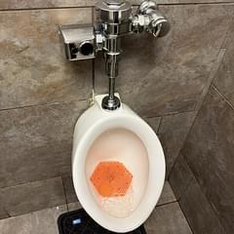 Flushometer valve on urinal adjusted to prevent overflow