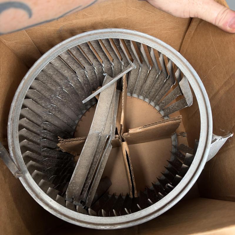 Blower wheel with broken blades in cardboard box