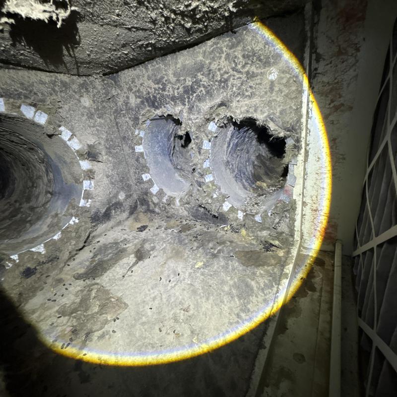 Duct air vent holes with damaged insulation and buildup