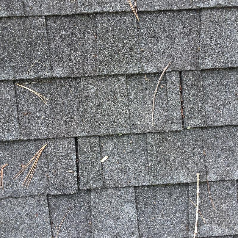 Asphalt roof shingles aging with debris buildup Asphalt roof shingles aging with debris buildup