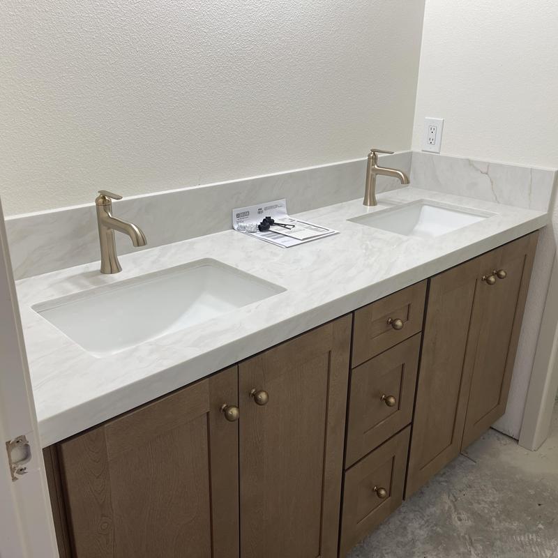 Bathroom faucets and pop-up drains on double vanity