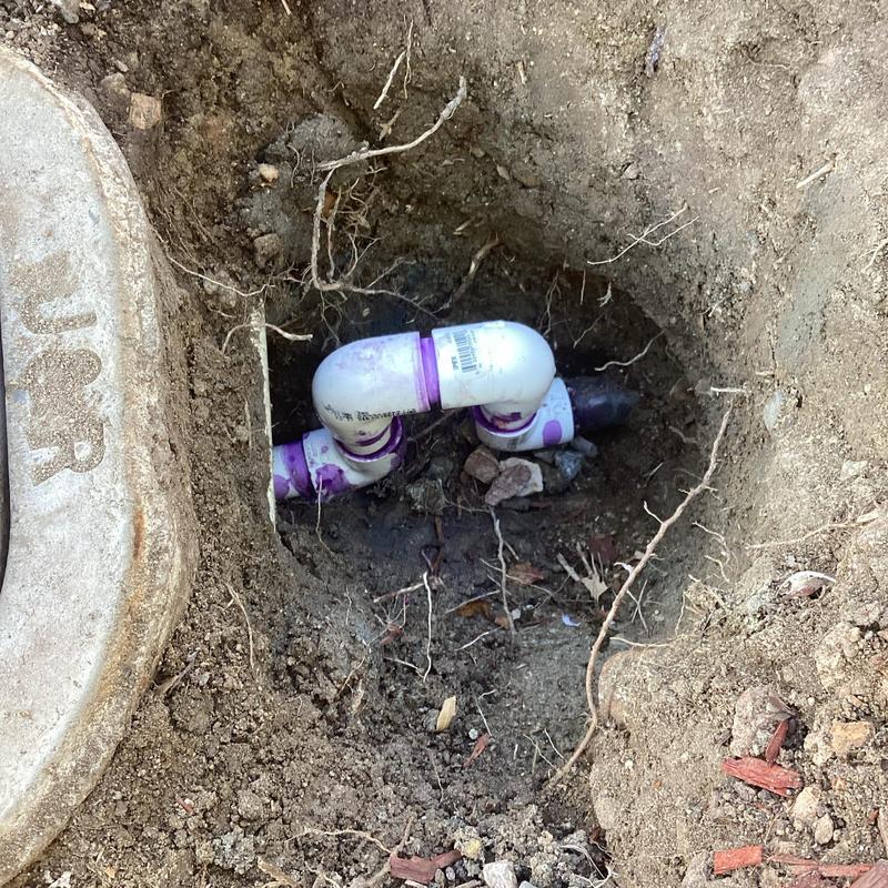 PVC water line with elbow fittings installed in ground