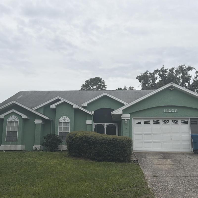 Shingled roof with multi-gabled design and garage door Shingled roof with multi-gabled design and garage door