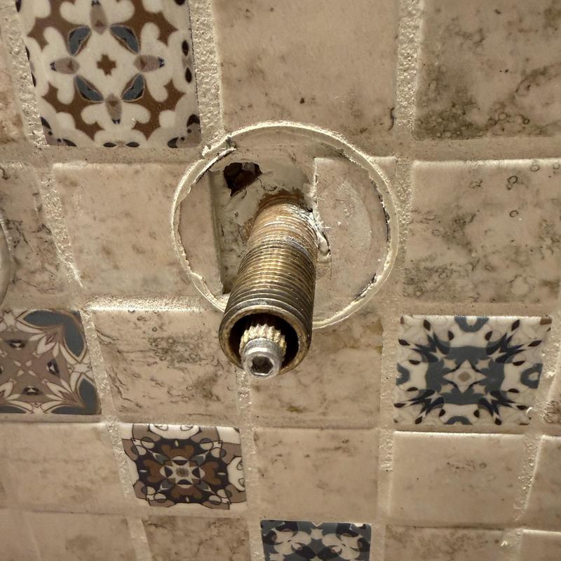 Faucet cartridge valve stem in tile wall opening