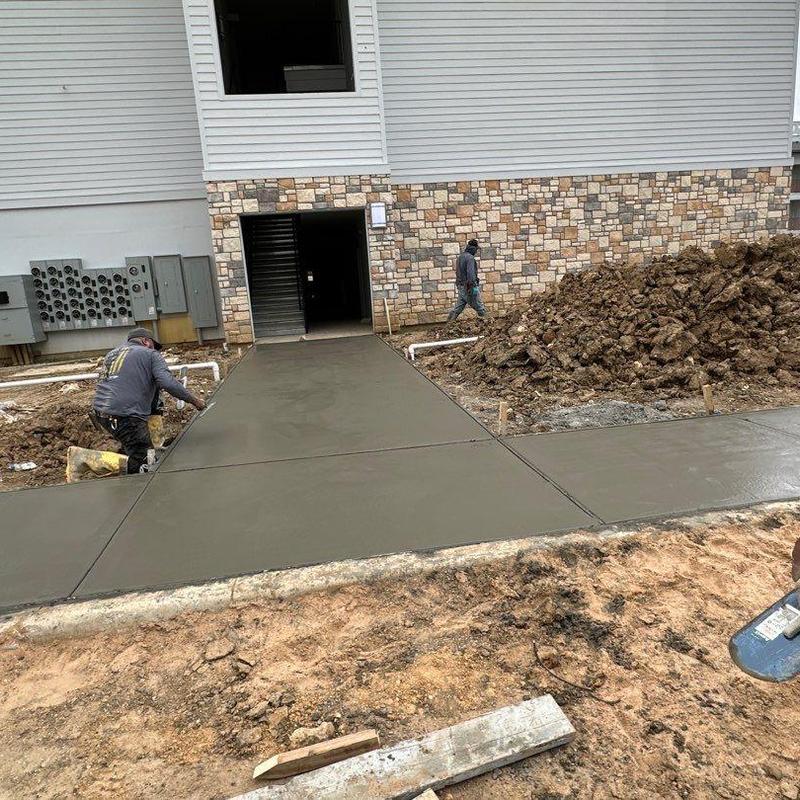 Concrete sidewalk installation at building entrance Concrete sidewalk installation at building entrance