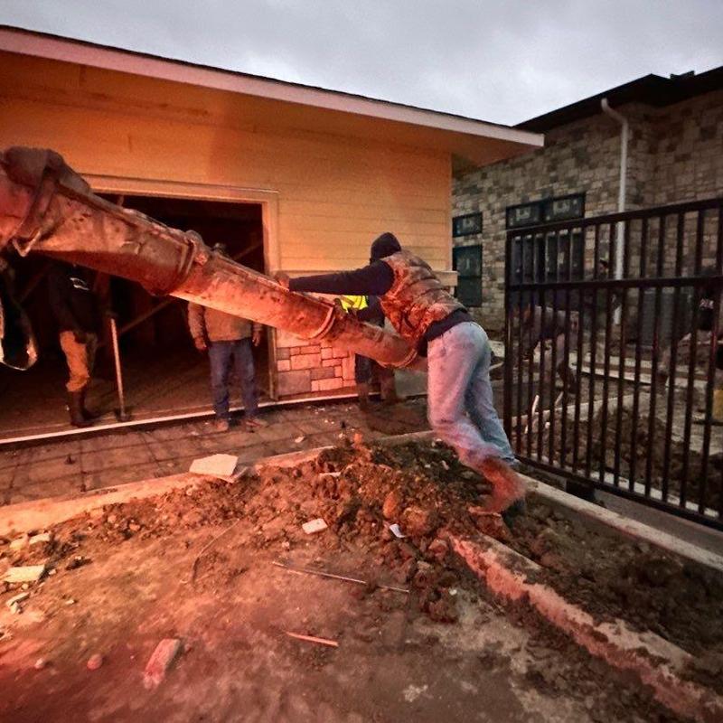 Concrete sidewalk pouring with workers at night Concrete sidewalk pouring with workers at night