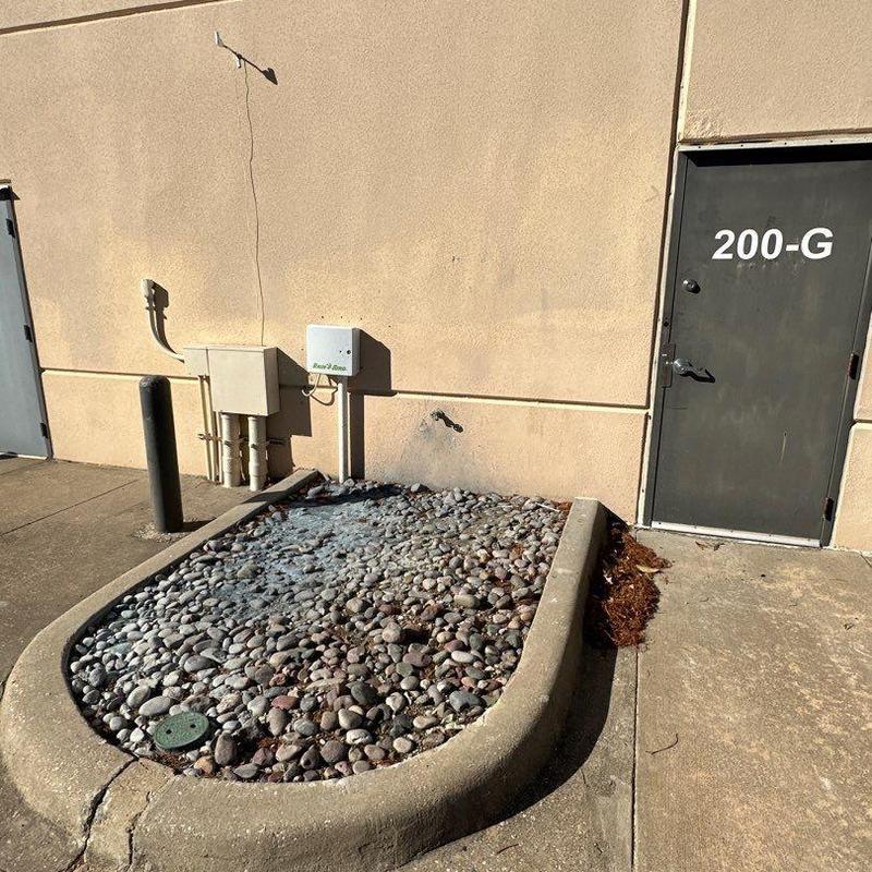 Stucco wall and door area with utility boxes Stucco wall and door area with utility boxes