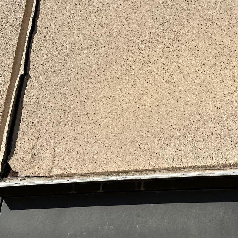 Stucco wall corner with visible crack and damage Stucco wall corner with visible crack and damage