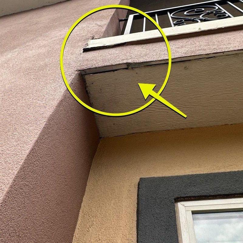 Balcony edge with damaged soffit and railing trim Balcony edge with damaged soffit and railing trim