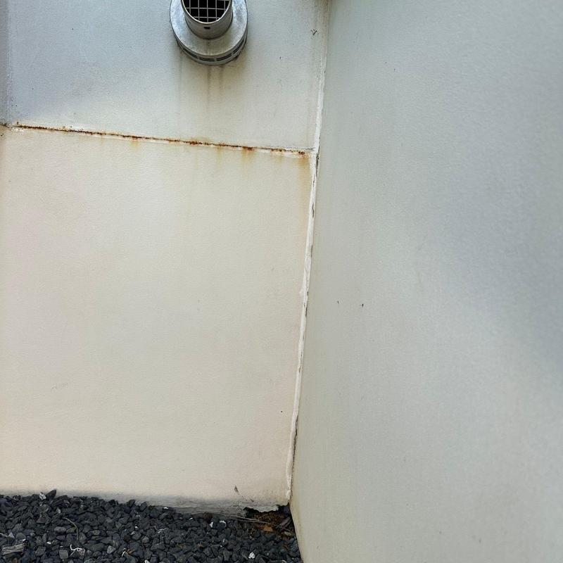 Vent pipe and stucco wall corner with rust and cracks Vent pipe and stucco wall corner with rust and cracks