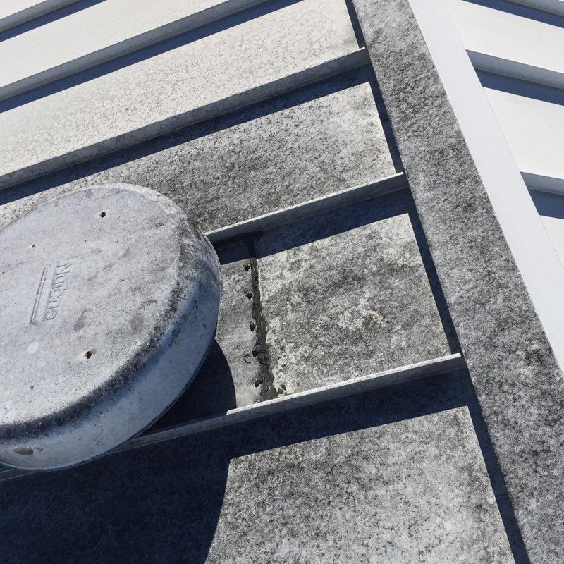 Metal roof panel with sealant repair and vent cover