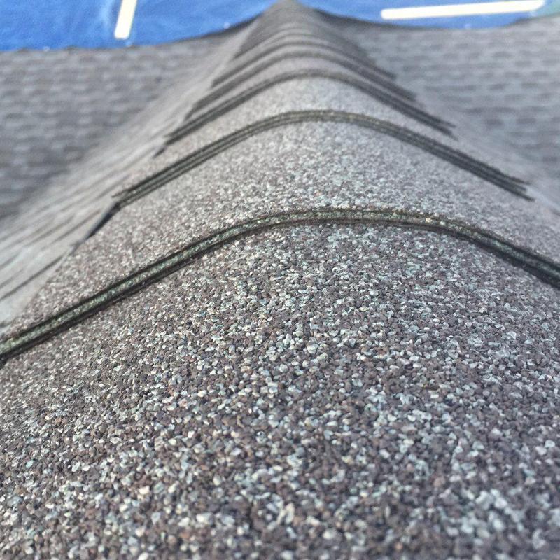 Charcoal-gray asphalt ridge shingles on roof peak