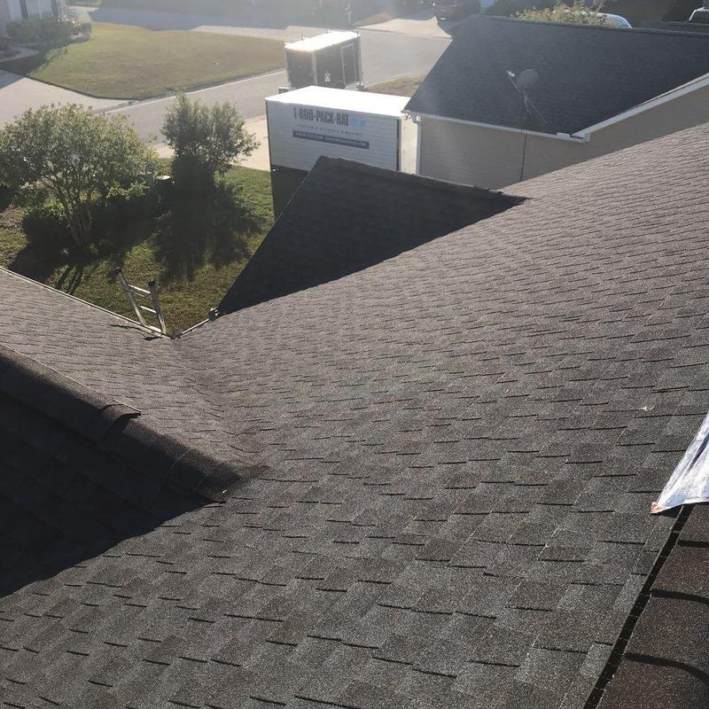 Charcoal-gray shingle roof replacement on home