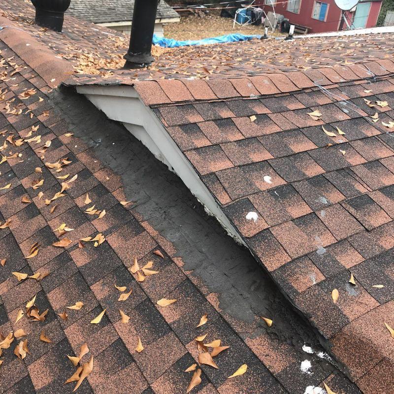 Roof valley with repaired shingles and sealed edges
