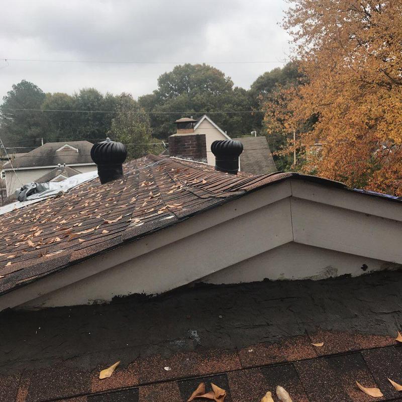 Storm-damaged roof shingles with repaired valley section