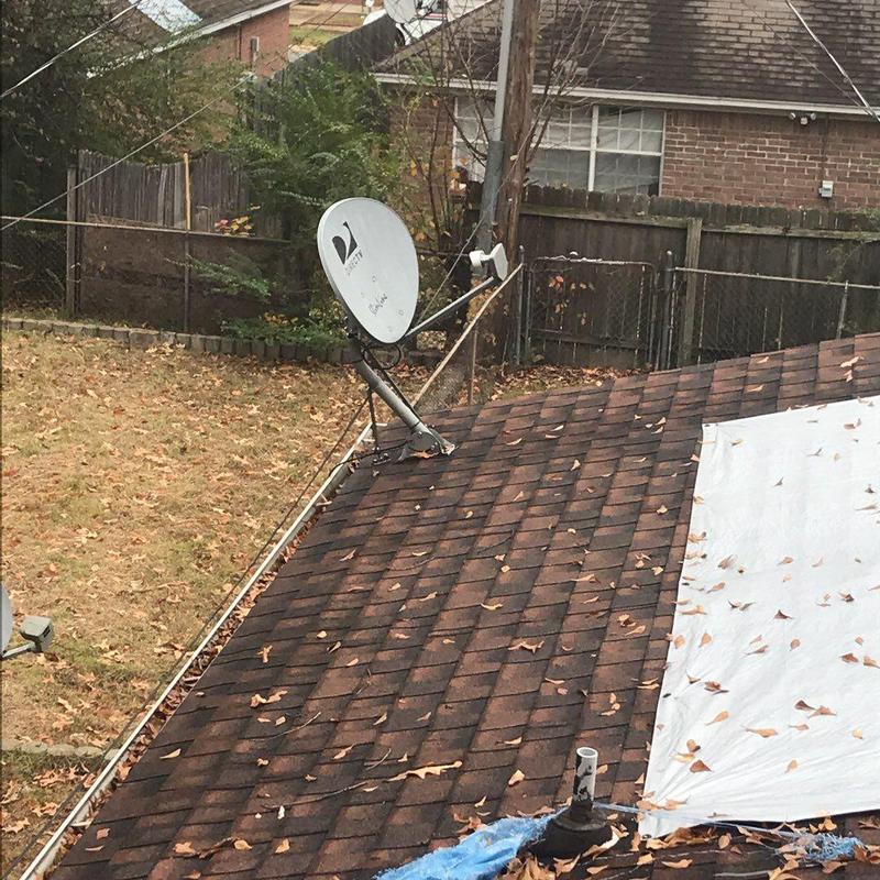 Asphalt shingle roof with satellite dish and tarp