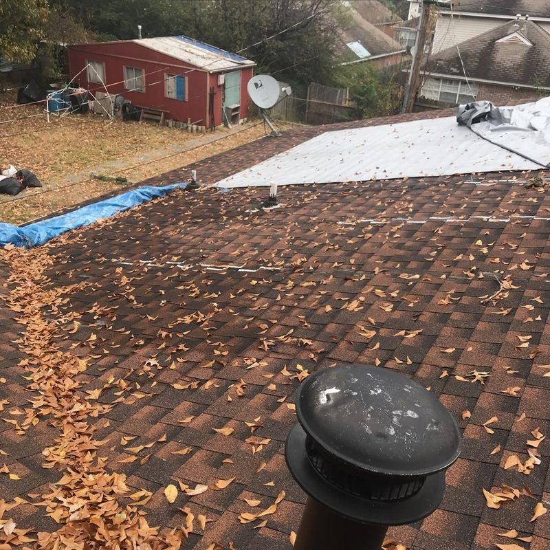 Asphalt shingles roof with storm damage repair and leaf accumulation