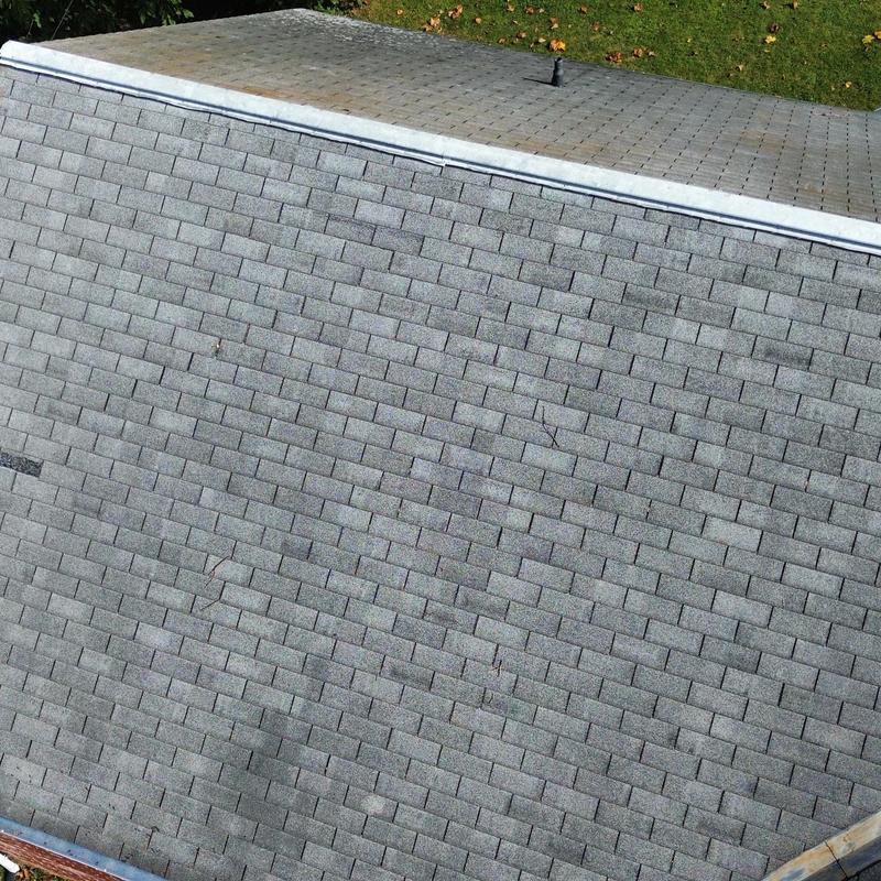 Asphalt shingle roof close-up with minor wear visible Asphalt shingle roof close-up with minor wear visible