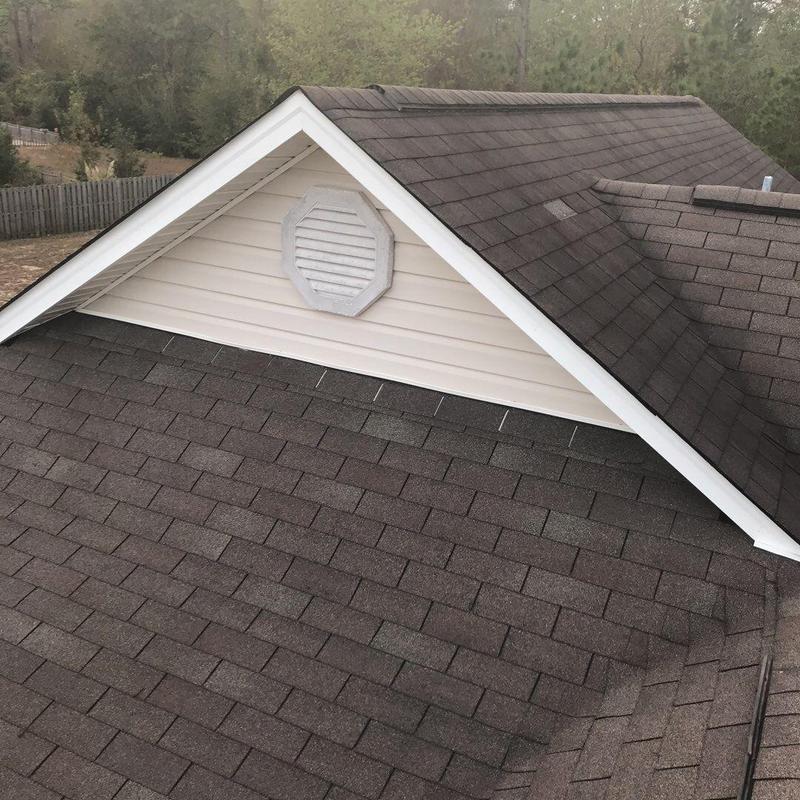 Brown shingle roof with ridge cap and flashing detail