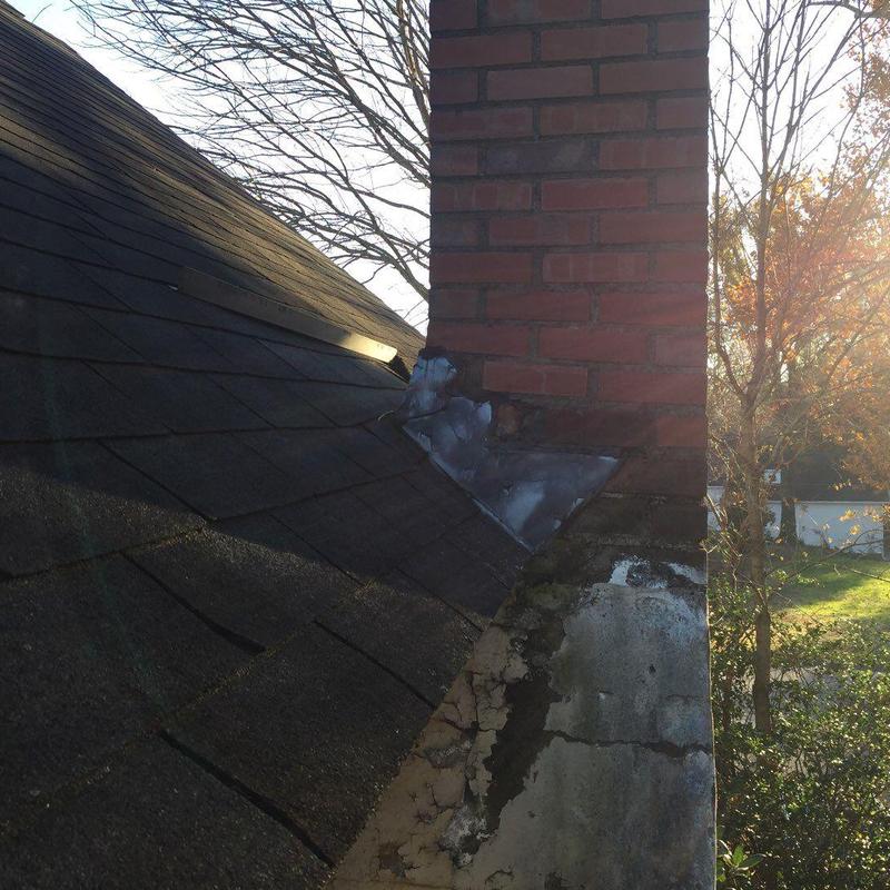 Chimney flashing and charcoal-gray shingle roof panel