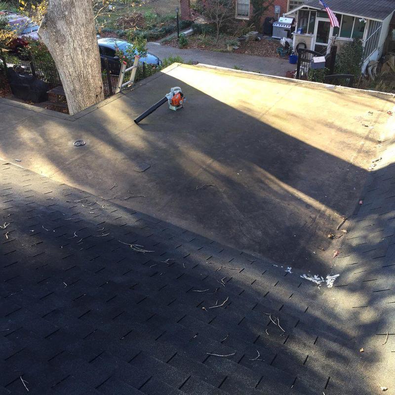 Flat roof membrane with leaf blower on surface