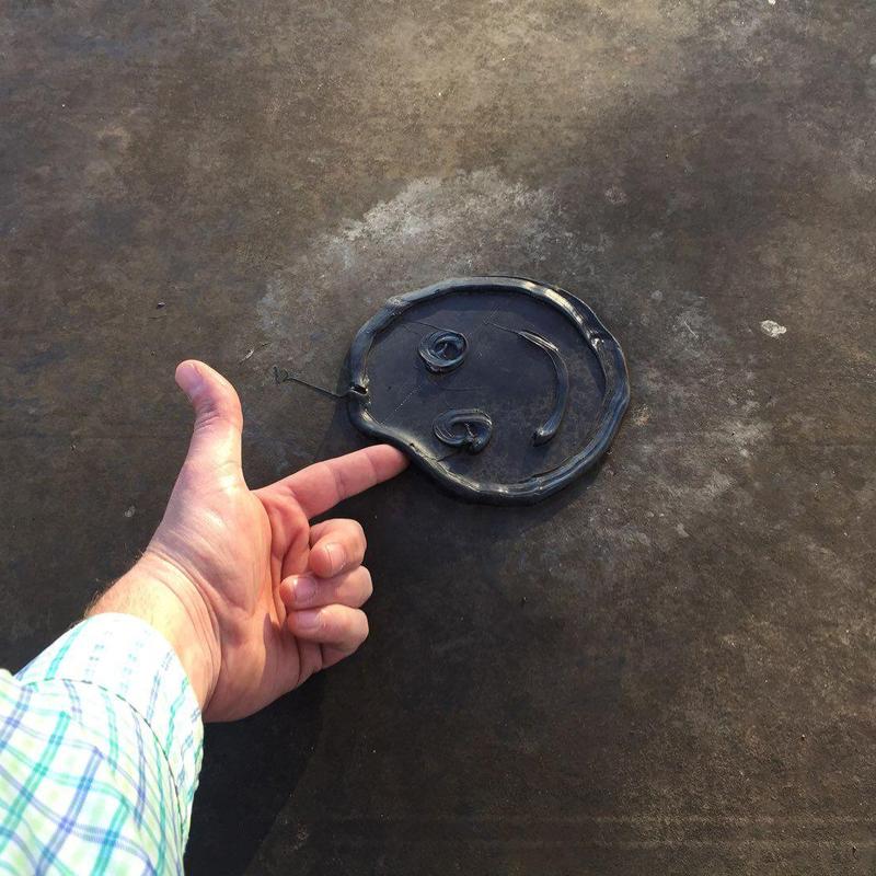 Metal roof panel with raised smiley face detail