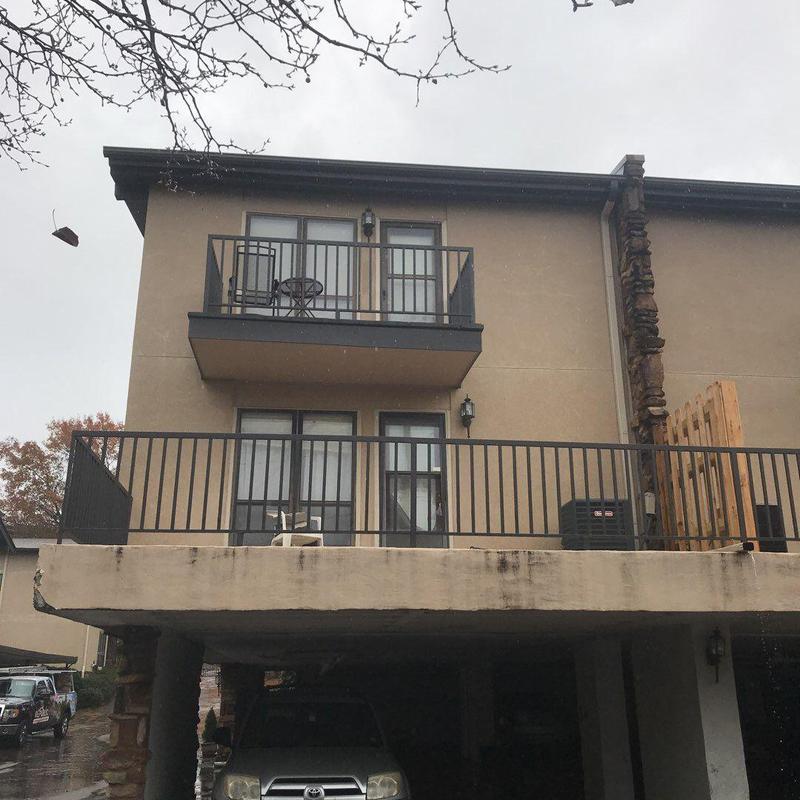 Concrete balcony with metal railing on residential building