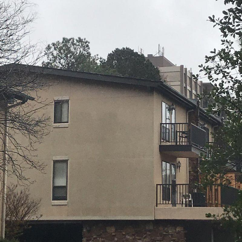 Concrete exterior wall with balcony and windows