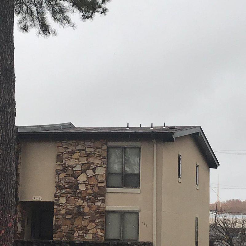 Concrete and shingle roofing on two-story condo building