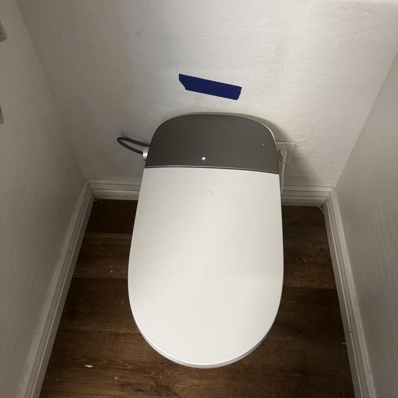 Electric smart toilet installed in corner restroom