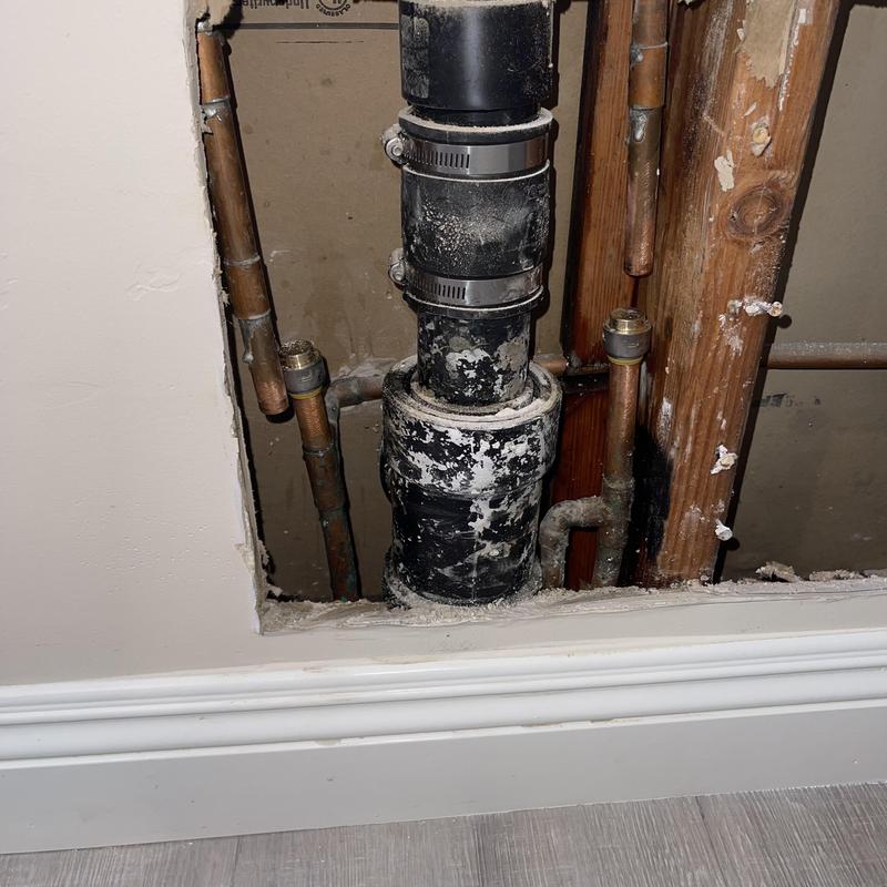 PVC drain pipe with copper supply lines in wall cavity