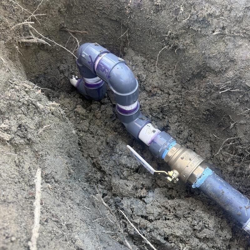 2-inch PVC pipe with ball valve installation in soil