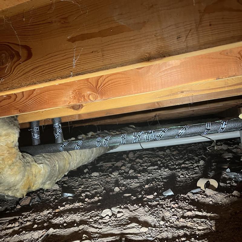 Waterline pipes with black foam insulation in crawlspace Waterline pipes with black foam insulation in crawlspace