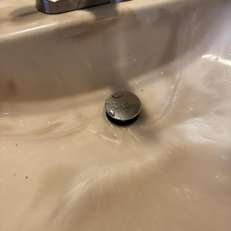 Bathroom sink drain stopper with water droplets Bathroom sink drain stopper with water droplets