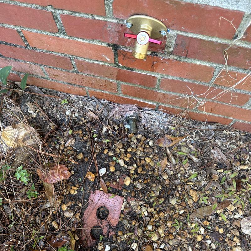 Outdoor hose bib valve installation on brick wall Outdoor hose bib valve installation on brick wall