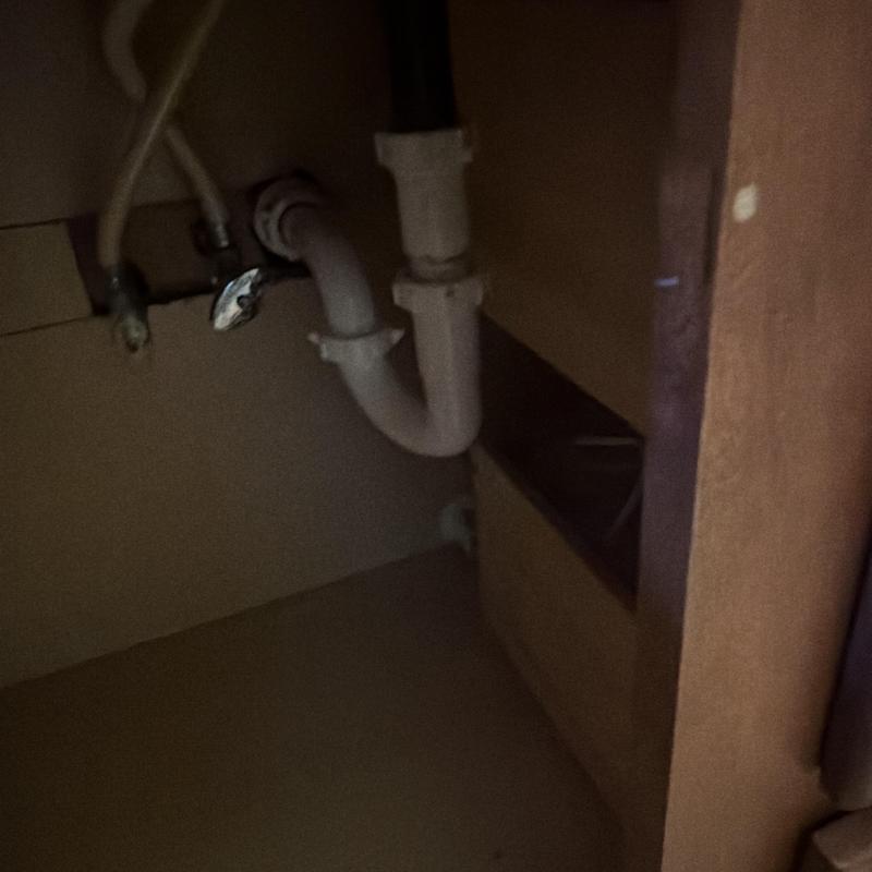 Sink drain pipes and water supply hoses under cabinet Sink drain pipes and water supply hoses under cabinet