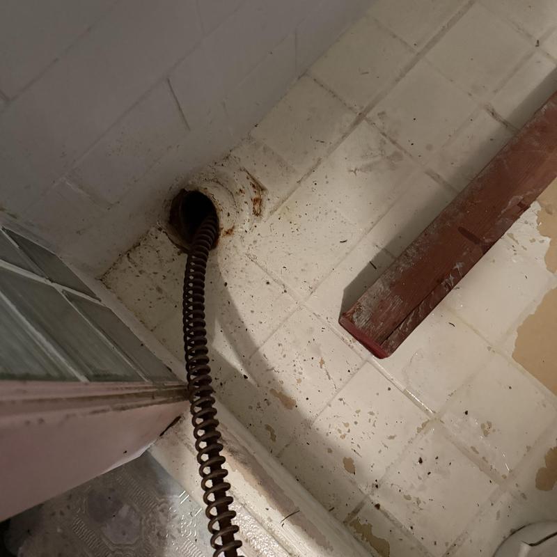 Main line sewer drain with drain snake cable inserted Main line sewer drain with drain snake cable inserted
