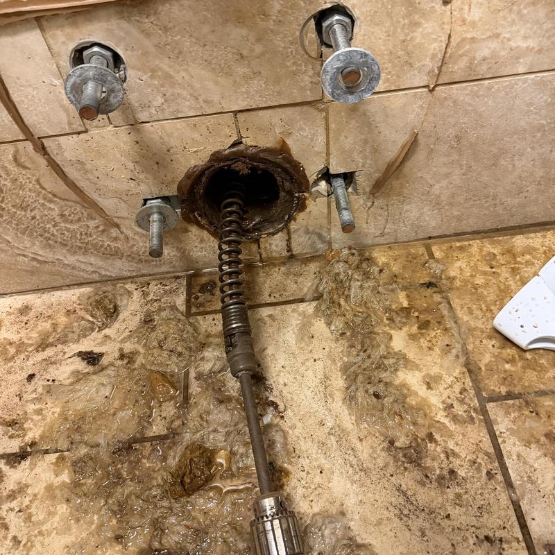 Toilet flange and bolts with plumbing snake clog removal Toilet flange and bolts with plumbing snake clog removal