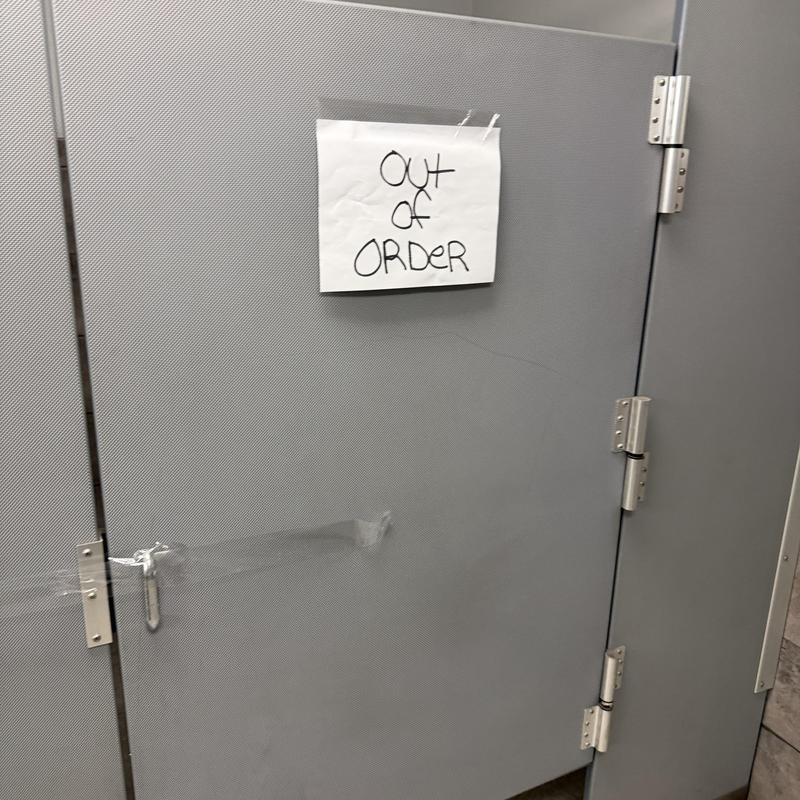 Commercial toilet stall door with out of order sign Commercial toilet stall door with out of order sign