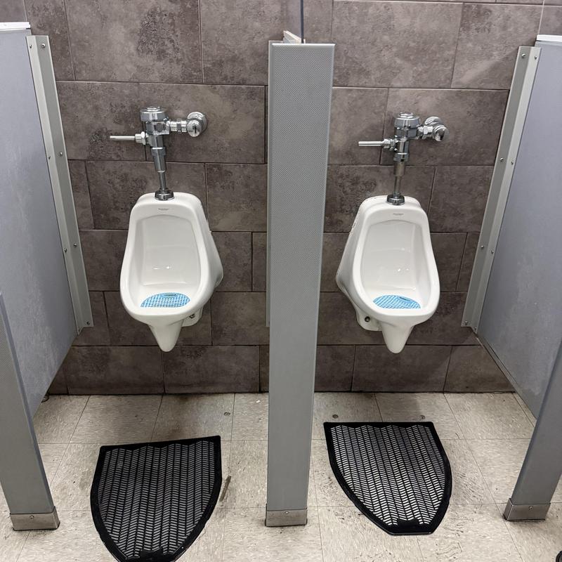 Commercial urinal flush valve installation in restroom Commercial urinal flush valve installation in restroom