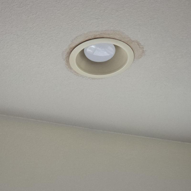 Recessed ceiling light with water stain around fixture
