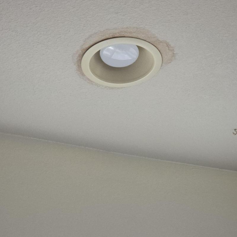 Ceiling recessed light with water damage stain