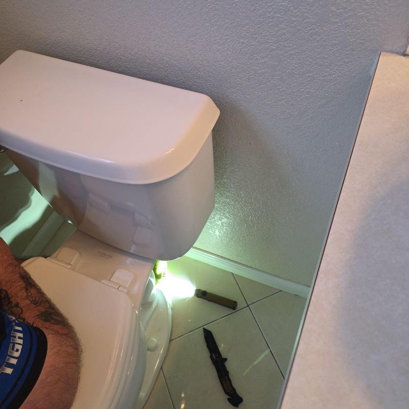 Toilet flange installation beside bathroom wall