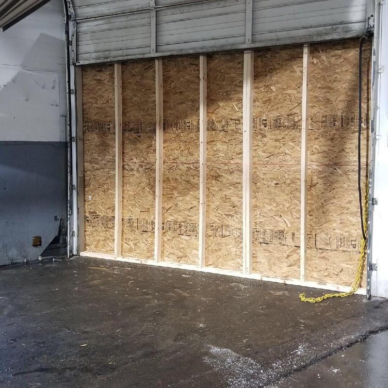 Service bay wall with new framing and sheathing