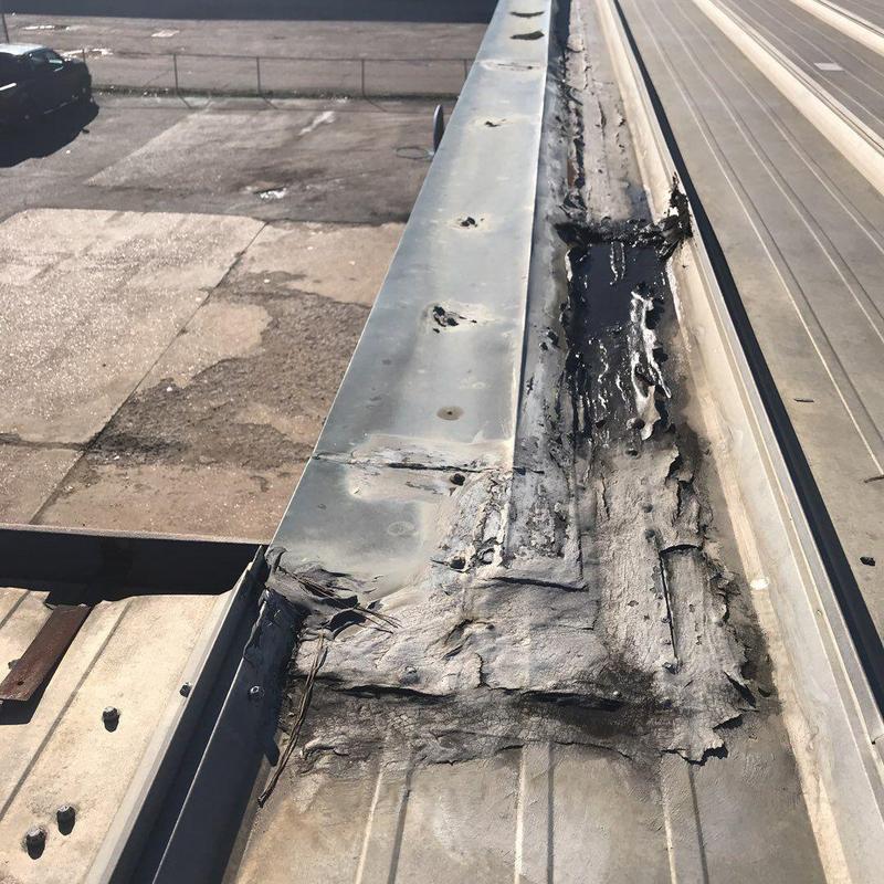 Metal roof flashing with patch repairs and sealant