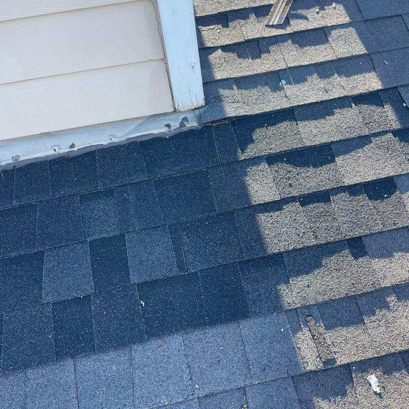 Asphalt shingle roof with repaired storm damage sections Asphalt shingle roof with repaired storm damage sections