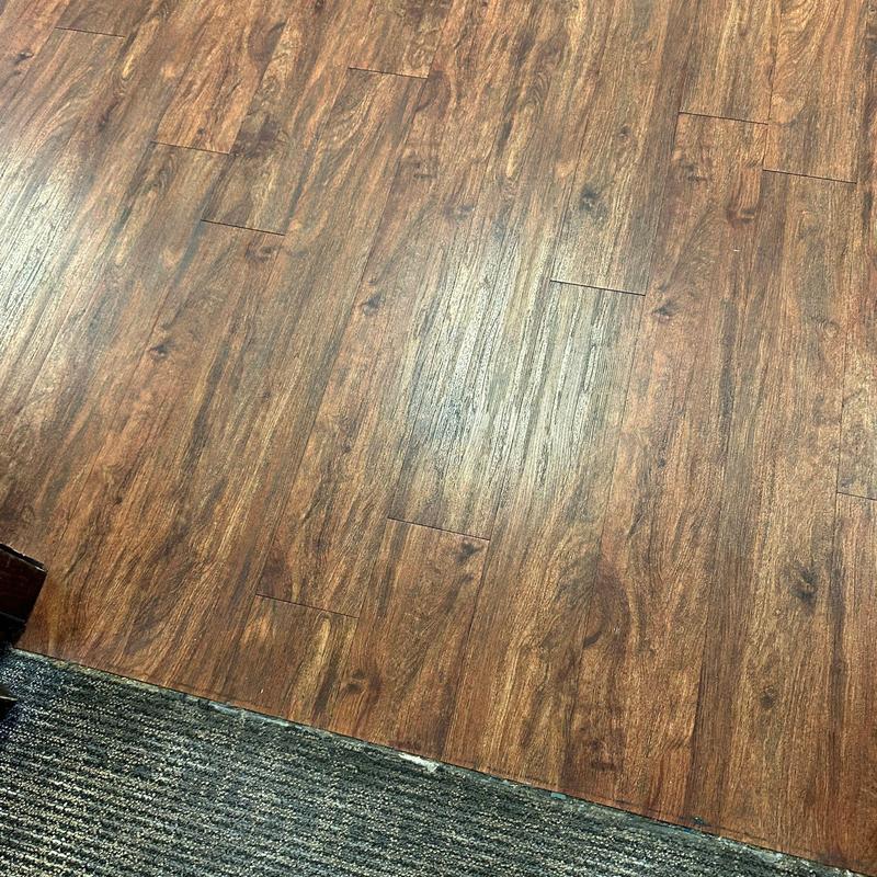 Wood-look vinyl flooring with damage and repairs Wood-look vinyl flooring with damage and repairs